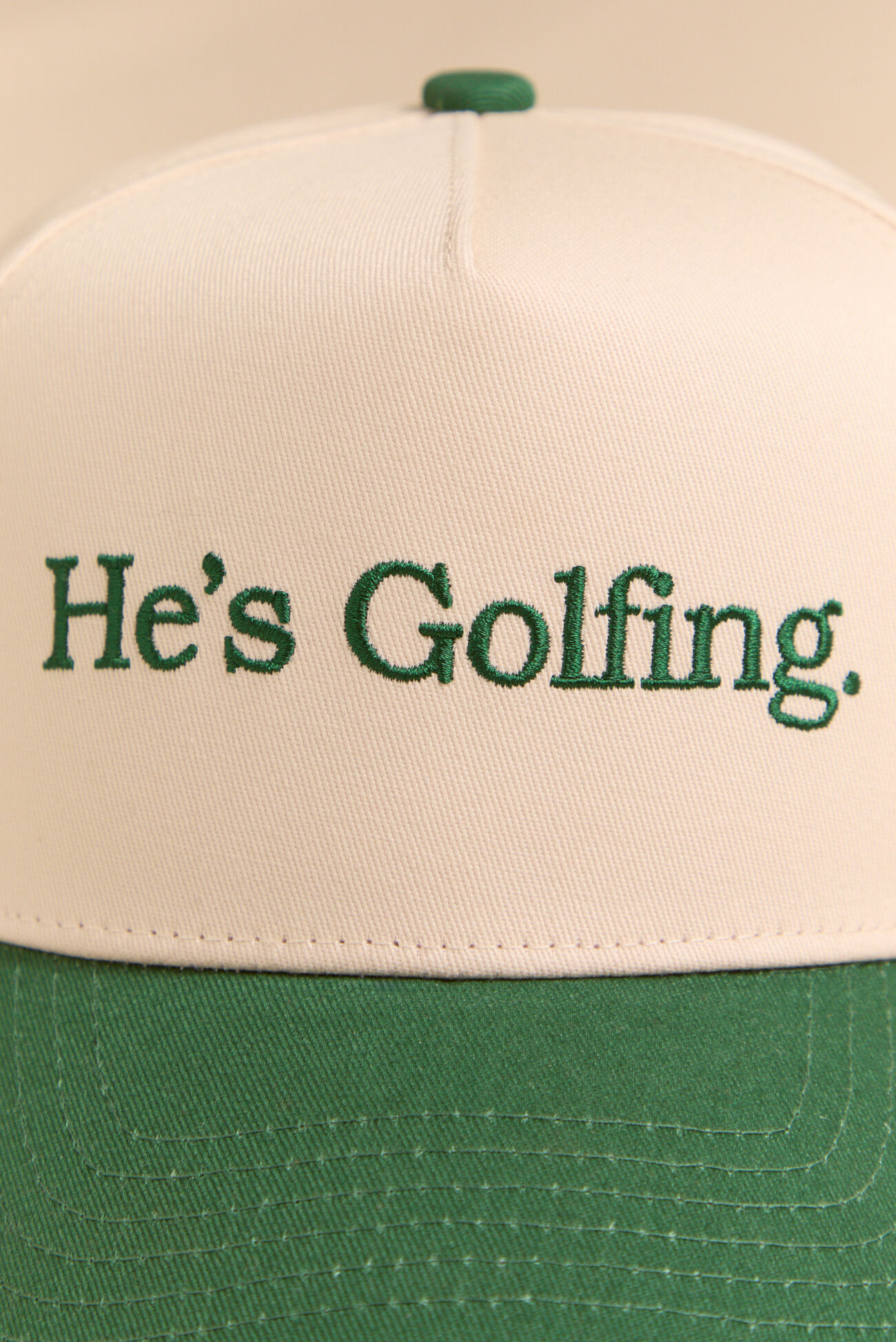 He's Golfing Trucker Hat