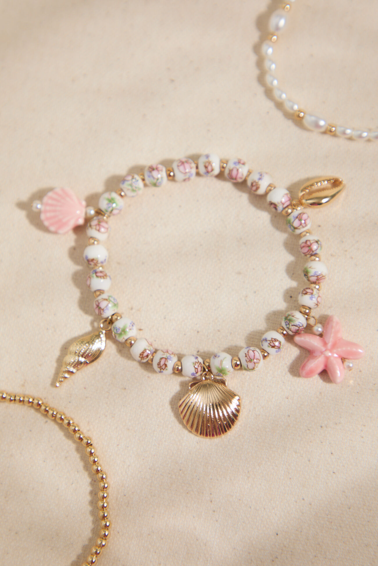 
        Beachy Bloom Charm Bracelet Set in Gold & Pink | Altar'd State
    