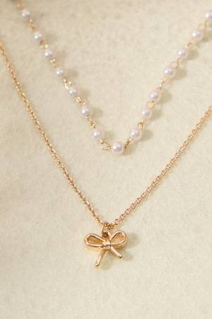 
        Bow Charm Pearl Layered Necklace in Gold | Altar'd State
    